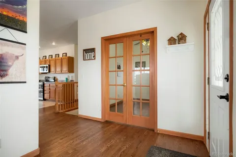 a view of walk in closet with wooden floor