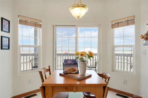 a dining room with furniture and a window