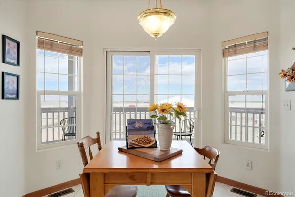 a dining room with furniture and a window