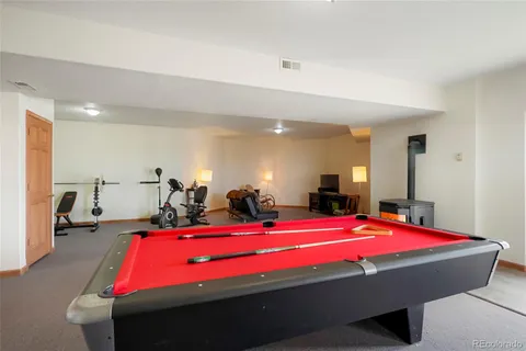 a room with gym equipment and a table