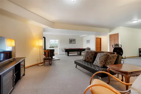 a living room with furniture gym equipment and a window