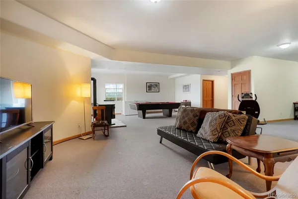 a living room with furniture gym equipment and a window