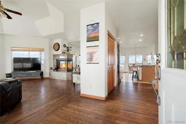 a view of a living room kitchen and a flat screen tv