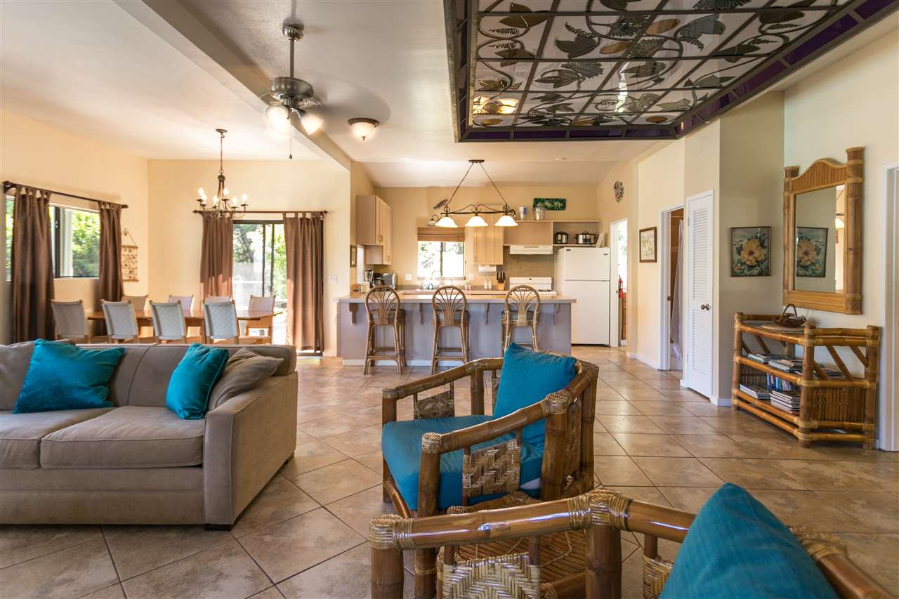 1555 West Kuiaha Road Haiku, HI 96708 - Photo 8 of 30 a living room with furniture a wooden floor and a chandelier