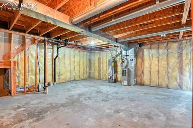 2049 Legacy Ridge View, Unit 111 Colorado Springs, CO 80910 - Photo 30 of 32 Unfinished below grade area with water heater and heating unit