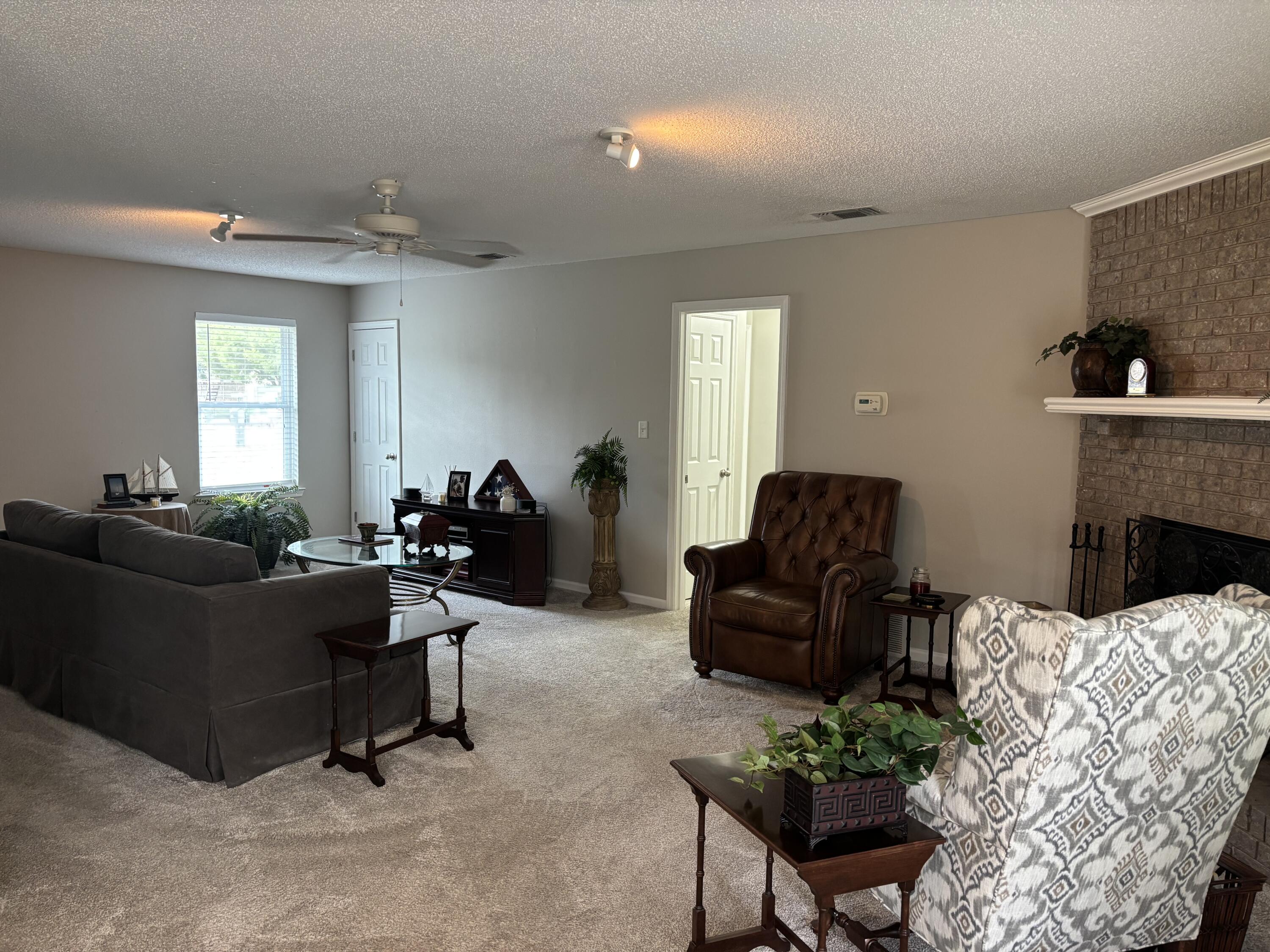 5367 Constitution Road Crestview, FL 32539 - Photo 12 of 25 a living room with furniture and a fireplace