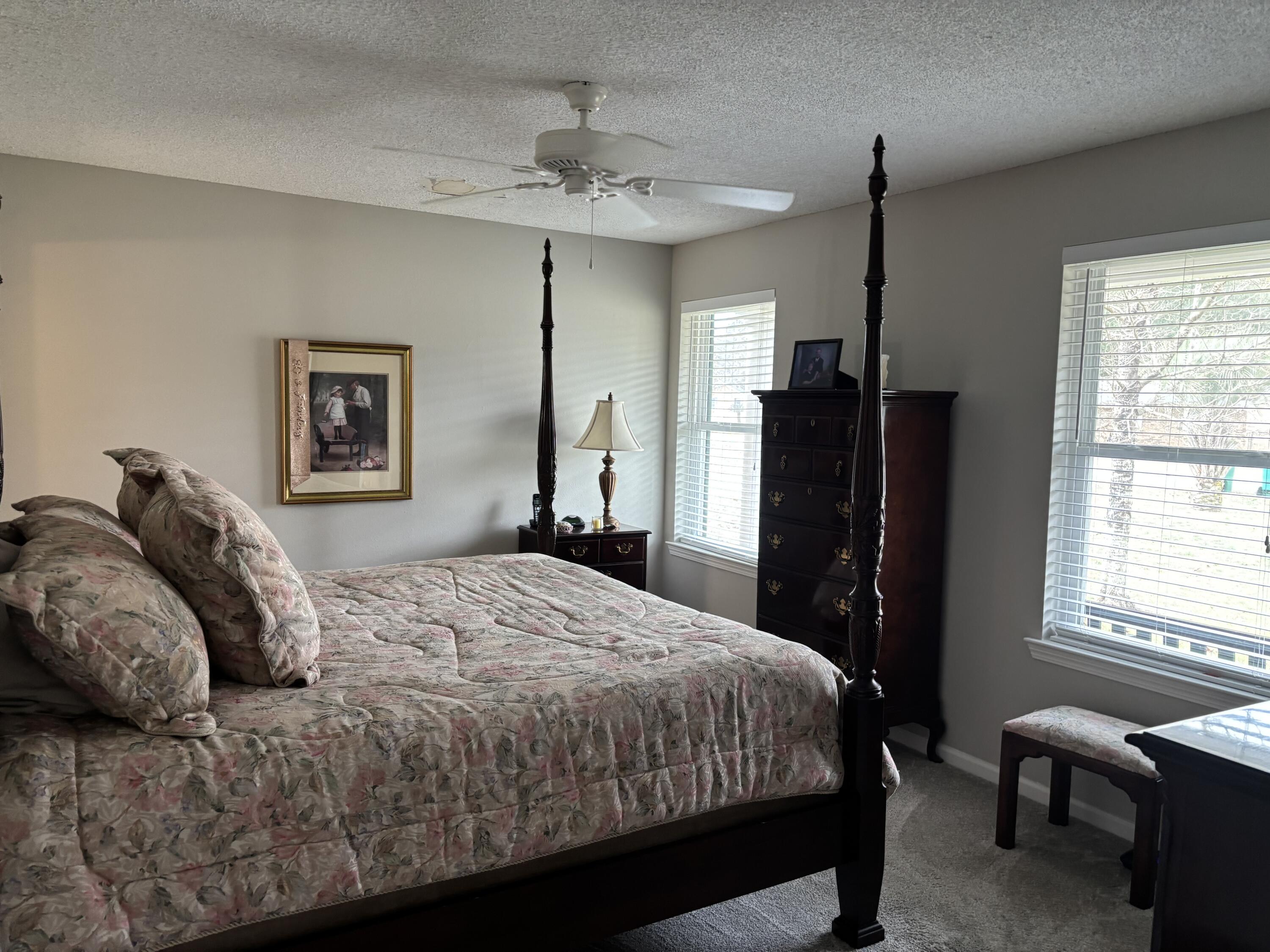 5367 Constitution Road Crestview, FL 32539 - Photo 15 of 25 a bedroom with a bed a chandelier and a flat tv screen