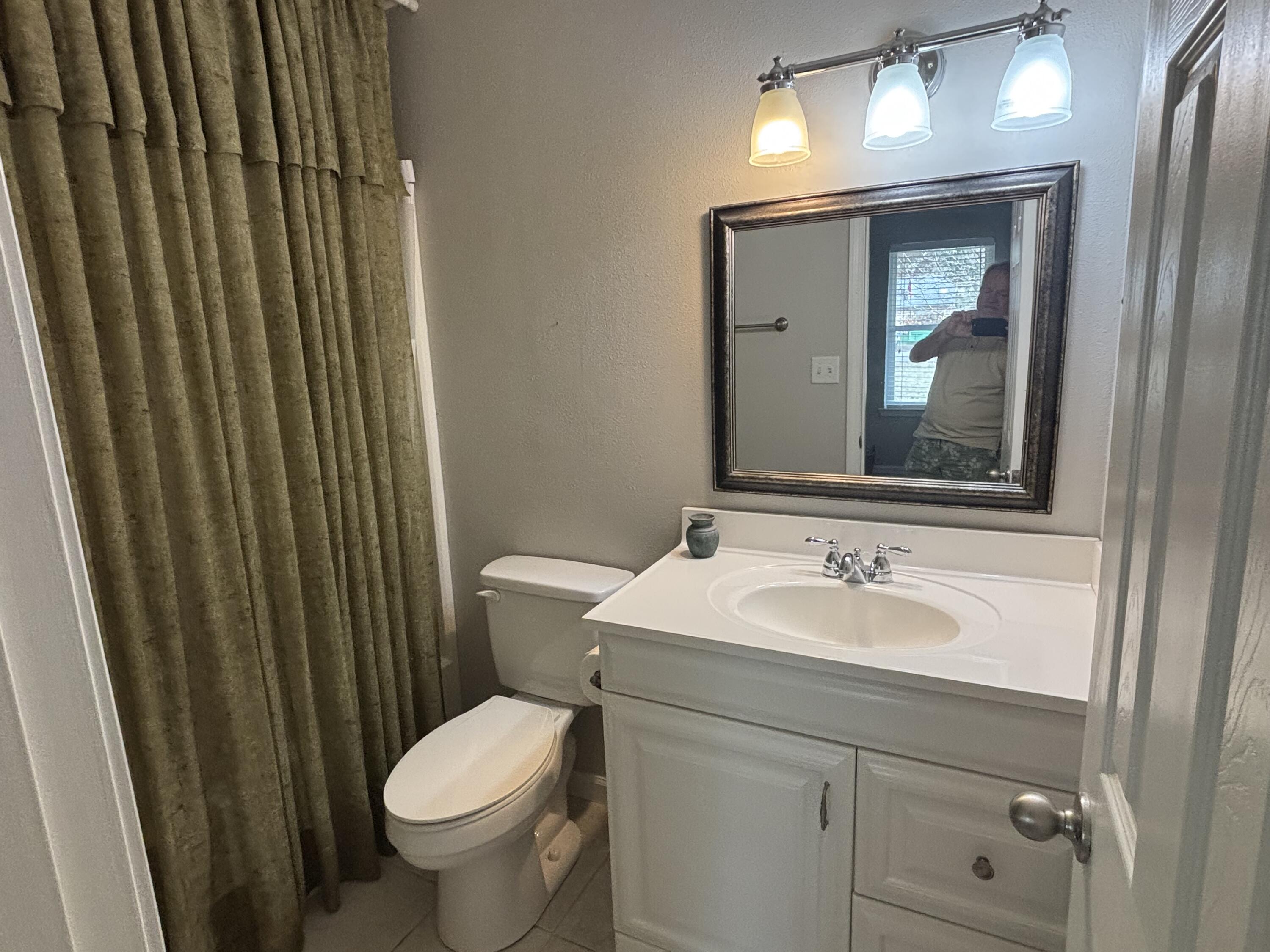 5367 Constitution Road Crestview, FL 32539 - Photo 16 of 25 a bathroom with a toilet a sink and mirror