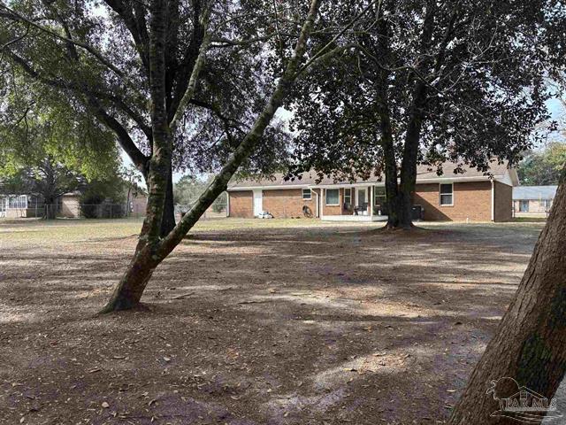 5367 Constitution Road Crestview, FL 32539 - Photo 21 of 25 a house with trees in front of it