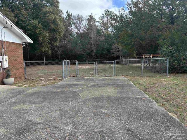 5367 Constitution Road Crestview, FL 32539 - Photo 22 of 25 a backyard of a house with lots of green space