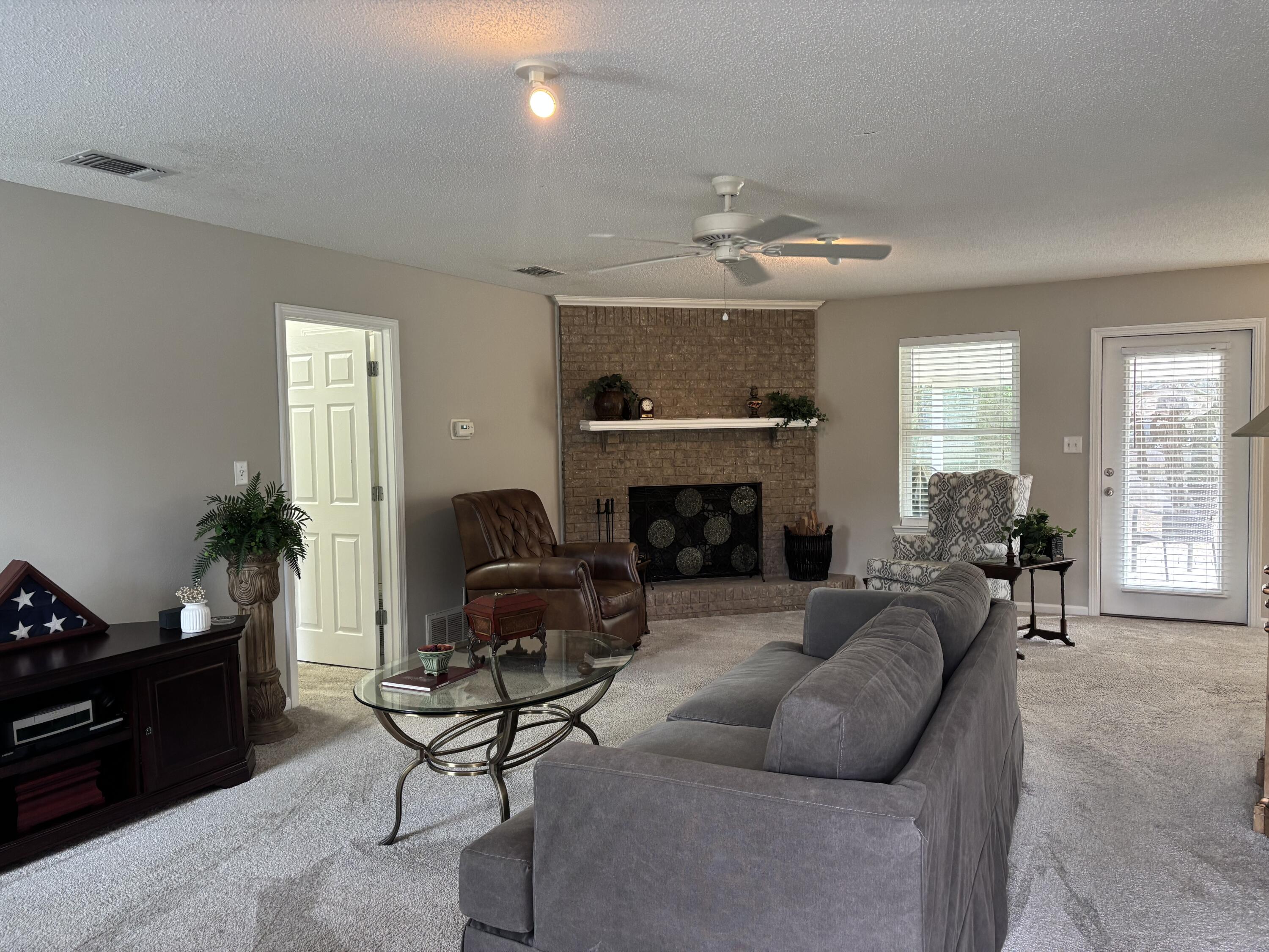 5367 Constitution Road Crestview, FL 32539 - Photo 4 of 25 a living room with furniture and a fireplace