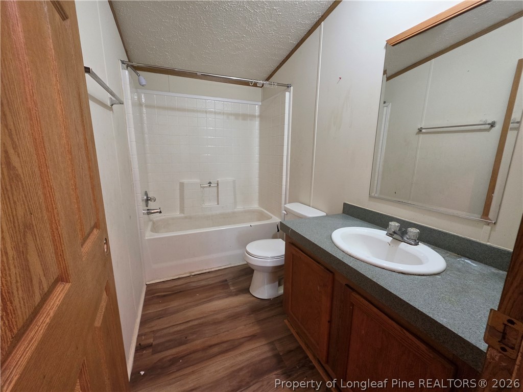 124 Franklin Road Raeford, NC 28376 - Photo 13 of 15 a bathroom with a granite countertop sink toilet a mirror and shower