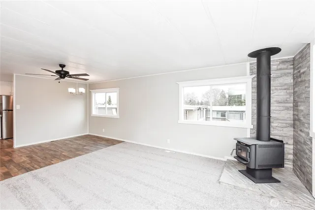 a view of a livingroom with a ceiling fan and window