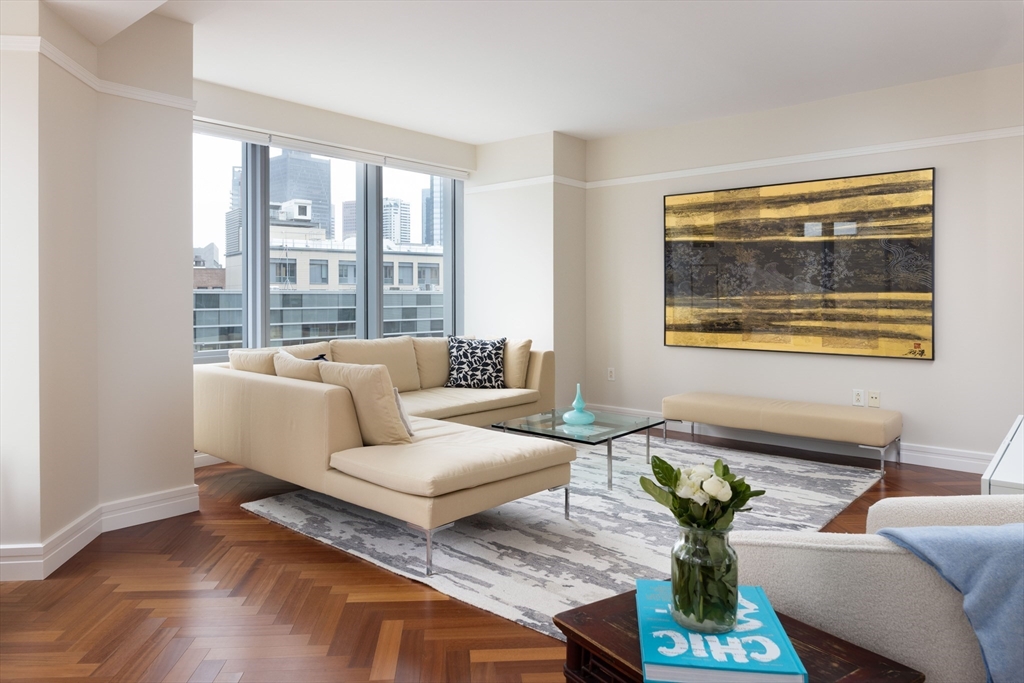1 Avery Street, Unit 12A Boston, MA 02111 - Photo 2 of 14 a living room with furniture and a potted plant