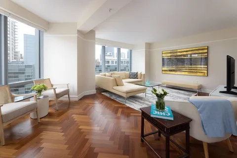 a living room with patio furniture and a window