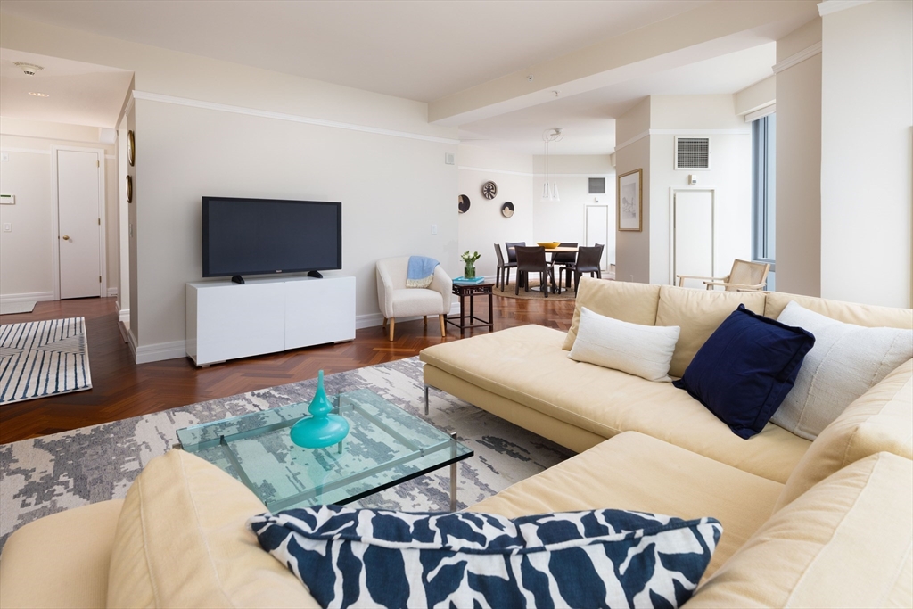1 Avery Street, Unit 12A Boston, MA 02111 - Photo 4 of 14 a living room with furniture and a flat screen tv