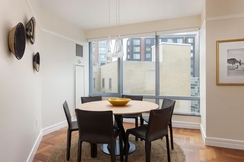 a dining room with furniture and window