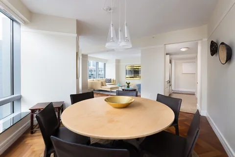a dining room with furniture and window