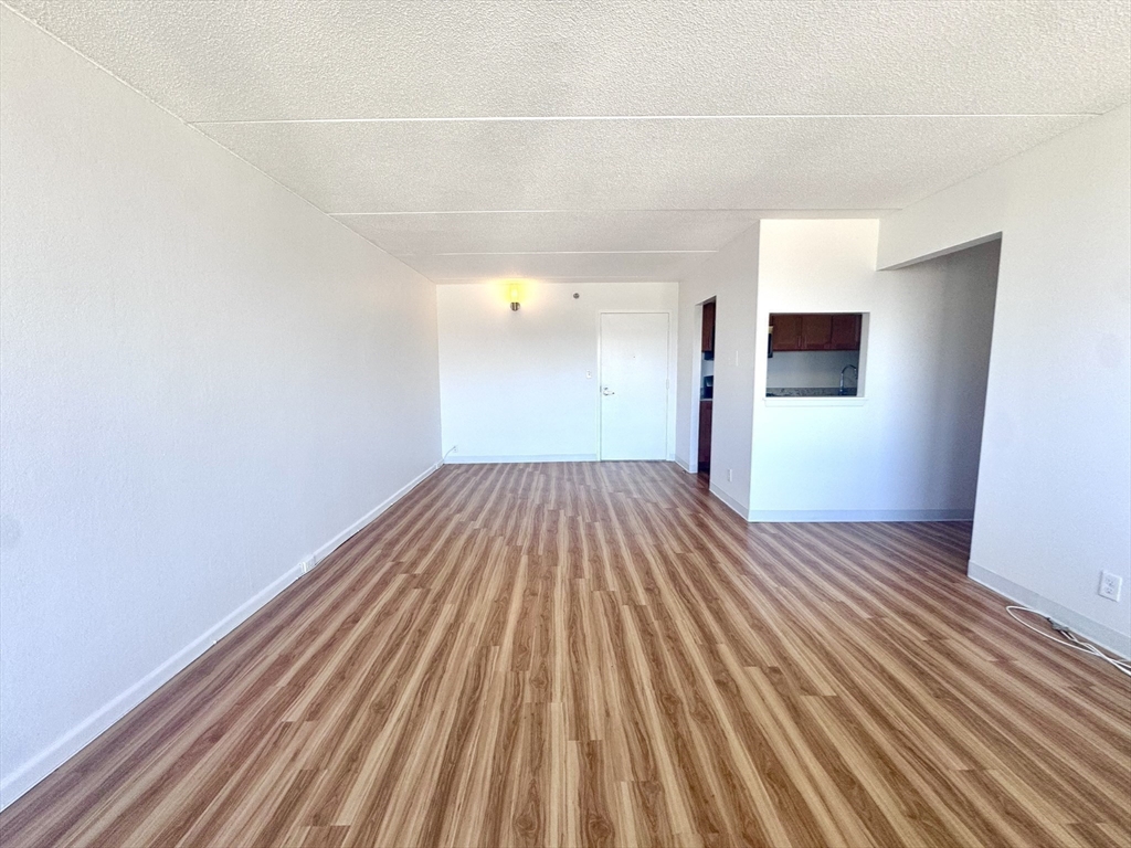 133 Park Street, Unit 404 Brookline, MA 02446 - Photo 23 of 25 a view of a room with wooden floor and a sink