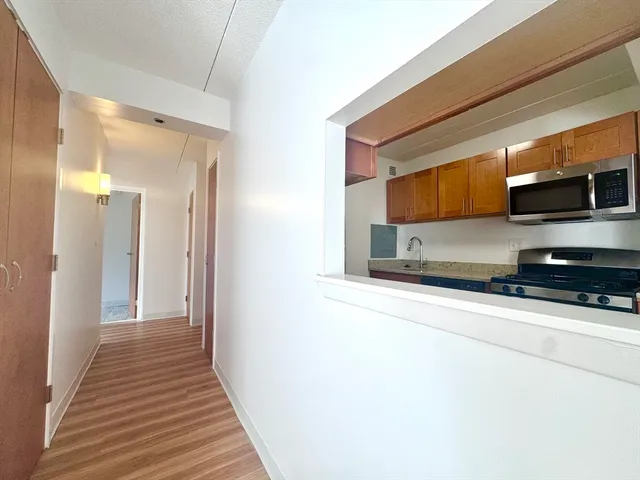 a view of a kitchen from a hallway