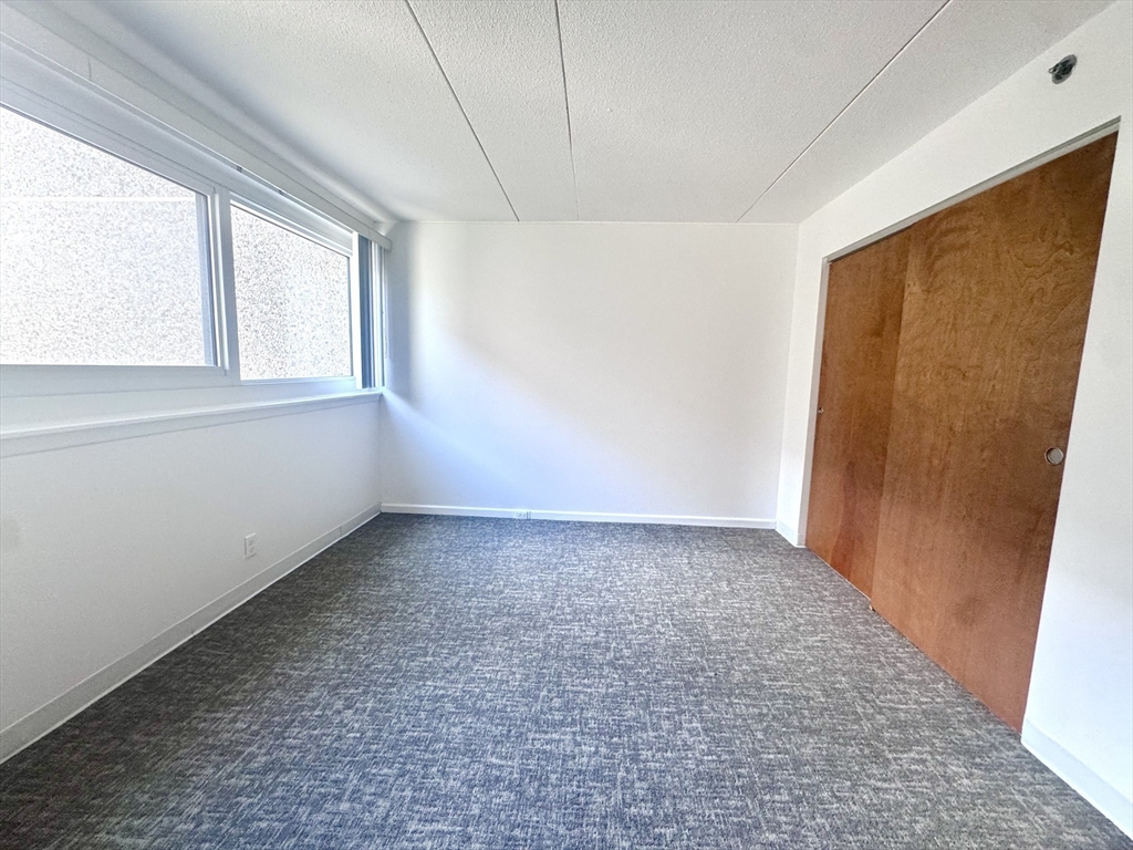 133 Park Street, Unit 404 Brookline, MA 02446 - Photo 8 of 25 a view of an empty room with a window