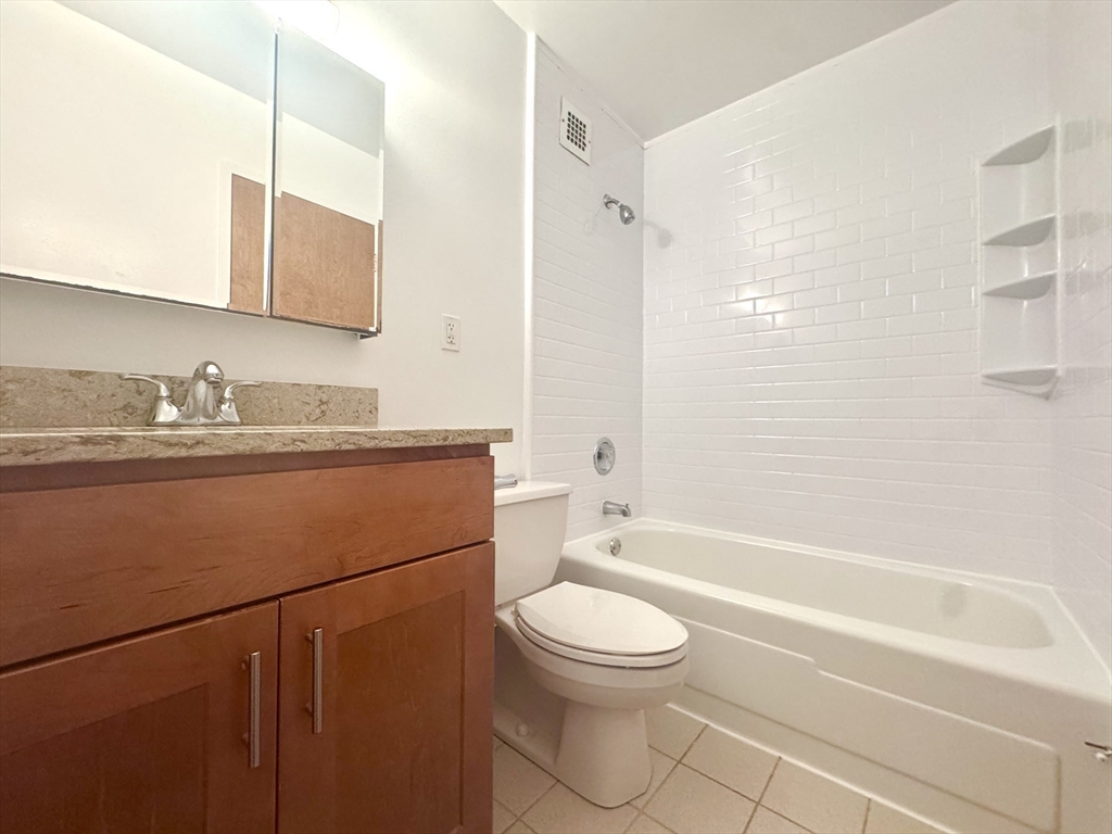 133 Park Street, Unit 404 Brookline, MA 02446 - Photo 9 of 25 a bathroom with a sink a toilet and shower
