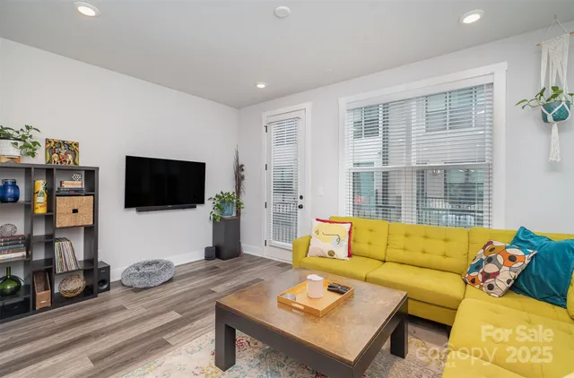 a kitchen with a sink a microwave a stove and white cabinets