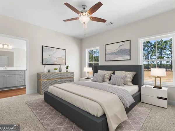 a bedroom with a large bed and a chandelier