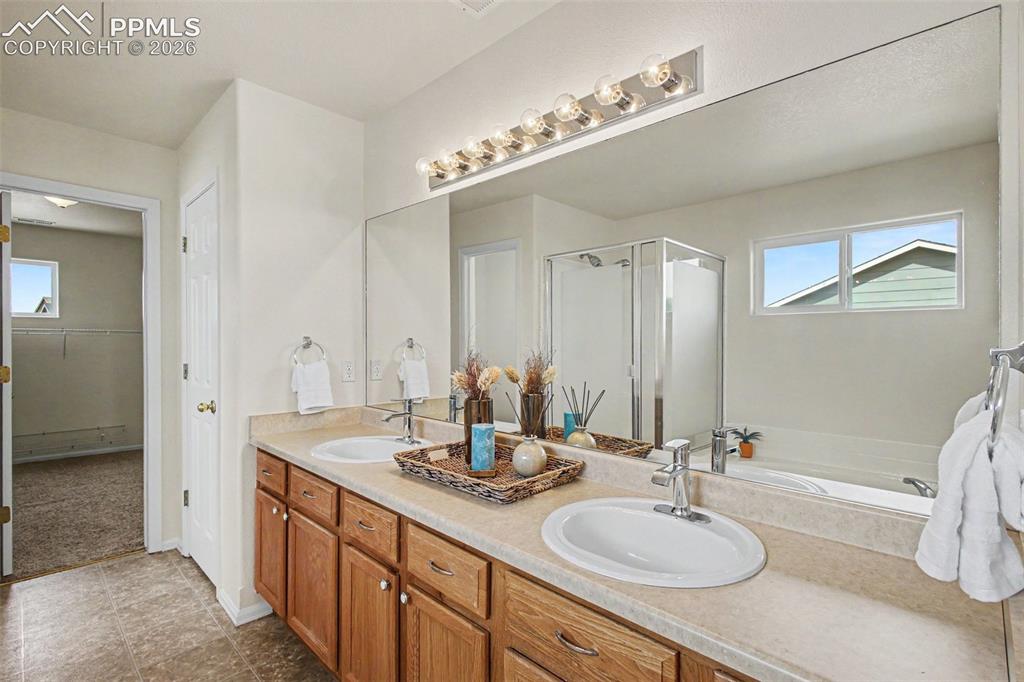 12210 Crystal Downs Road Peyton, CO 80831 - Photo 17 of 40 a bathroom with a double vanity sink mirror and double