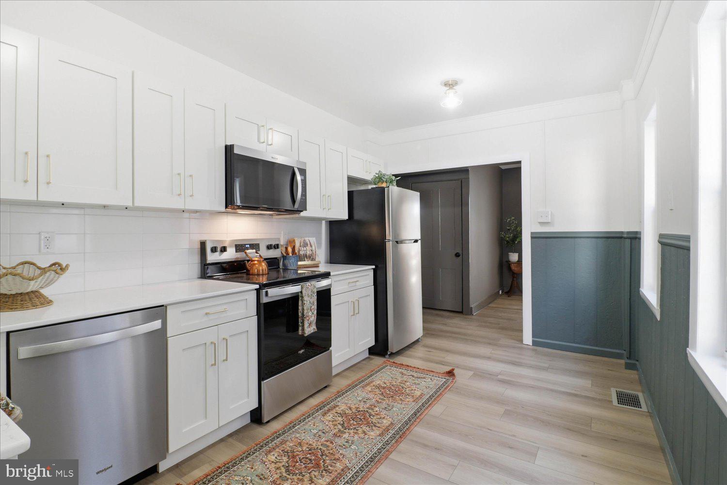 27 West New Street Lancaster, PA 17603 - Photo 7 of 29 a kitchen with stainless steel appliances granite countertop a refrigerator stove and microwave