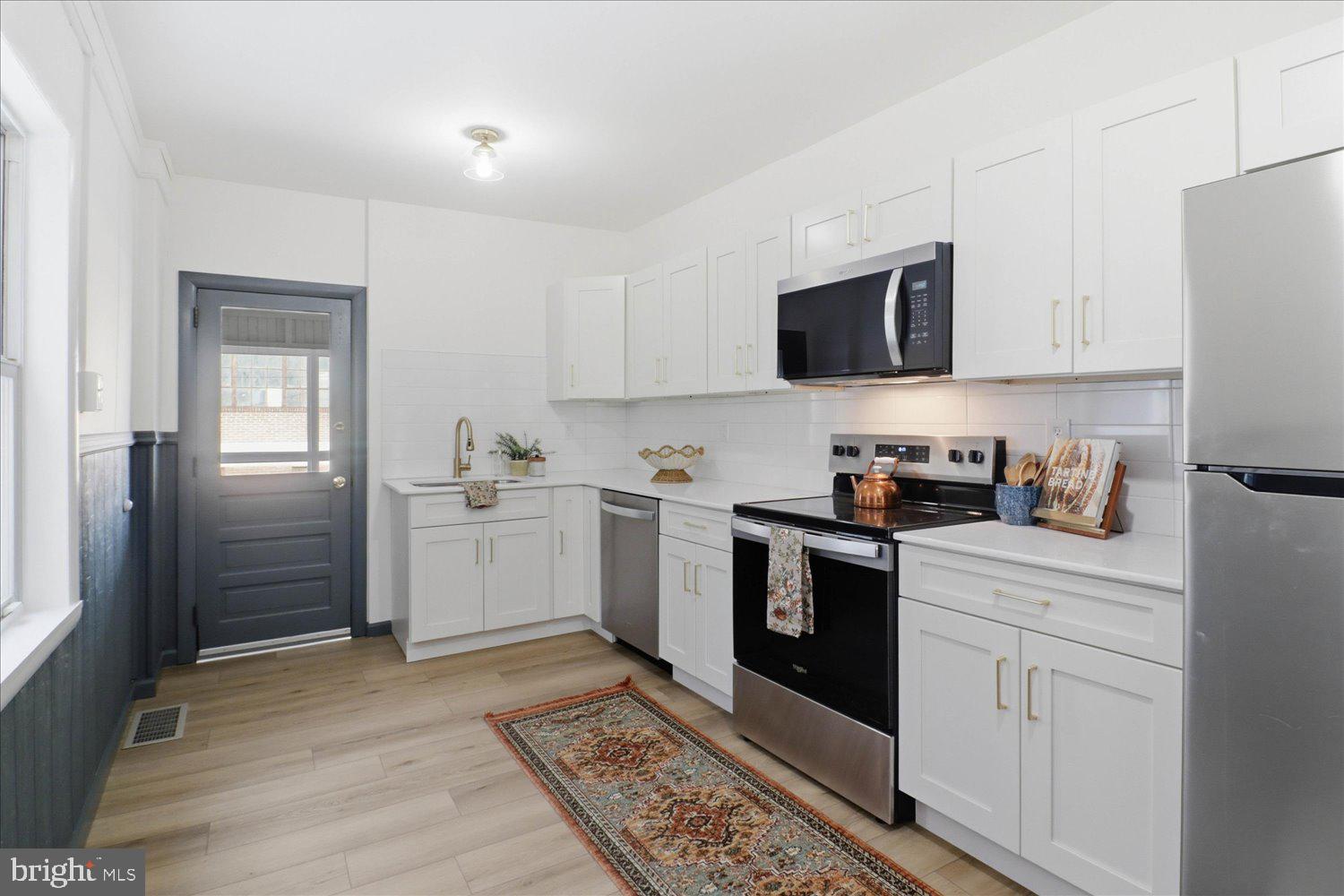 27 West New Street Lancaster, PA 17603 - Photo 8 of 29 a kitchen with stainless steel appliances granite countertop a refrigerator sink and white cabinets