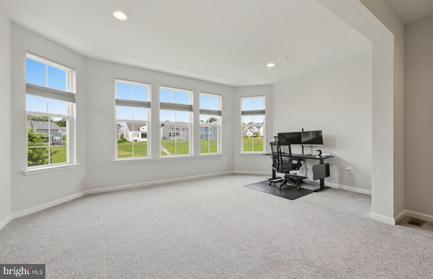 5707 Hawk Ridge Road Frederick, MD 21704 - Photo 40 of 109 a living room with furniture and a floor to ceiling window