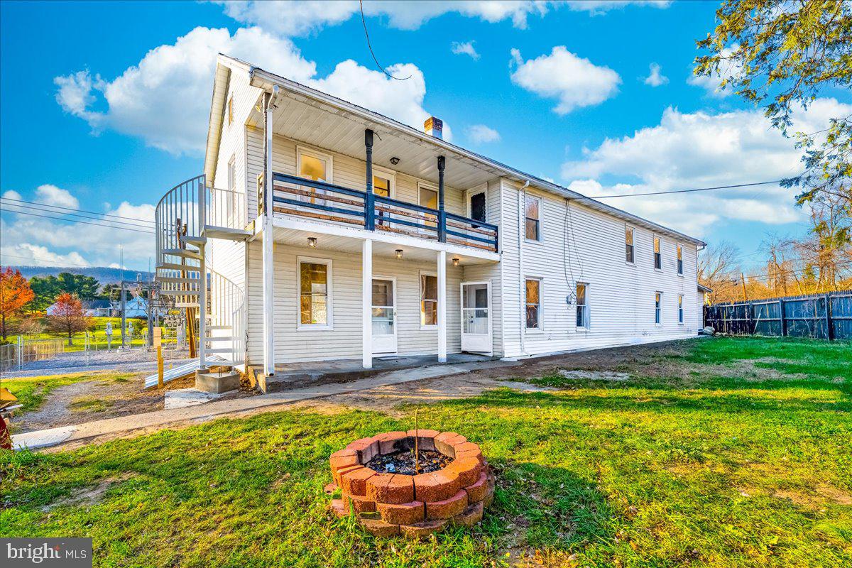 a front view of house with yard and outdoor seating