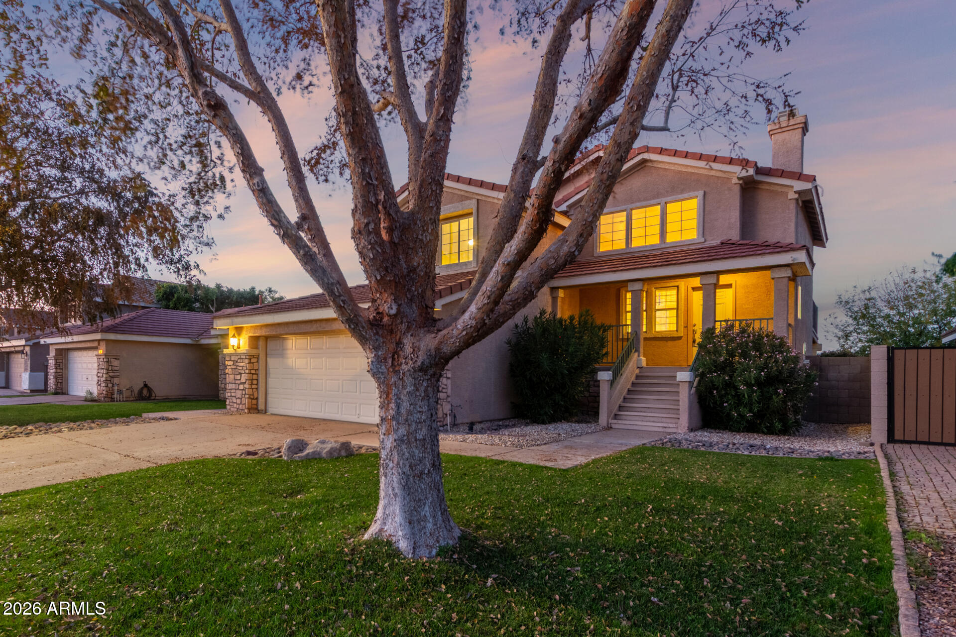 a view of a house with a tree and a yard