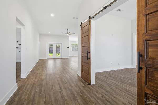 a view of a hallway with wooden floor