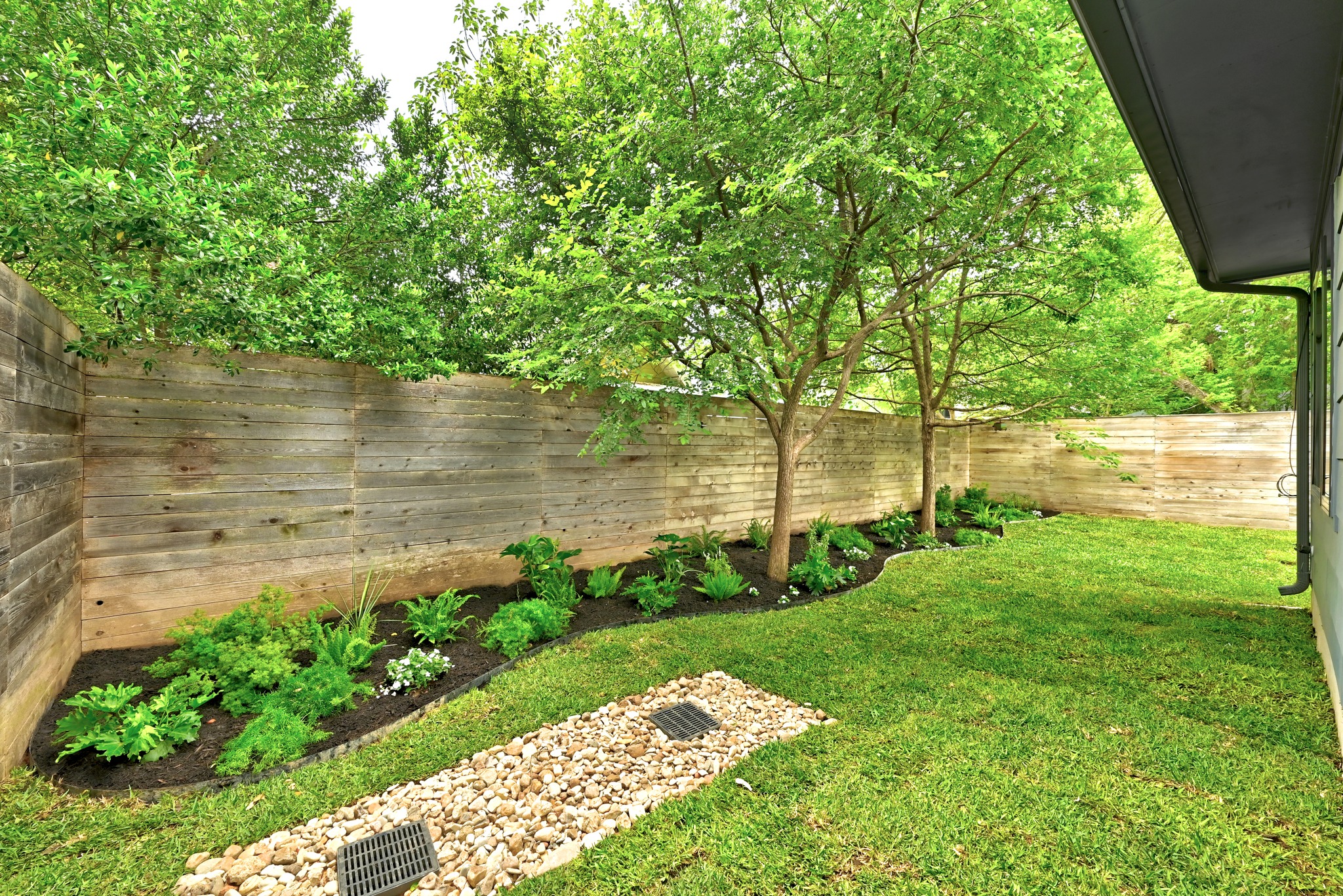 1609 Bauerle Avenue Austin, TX 78704 - Photo 27 of 34 Fully landscaped back yard with in ground sprinkler system throughout property