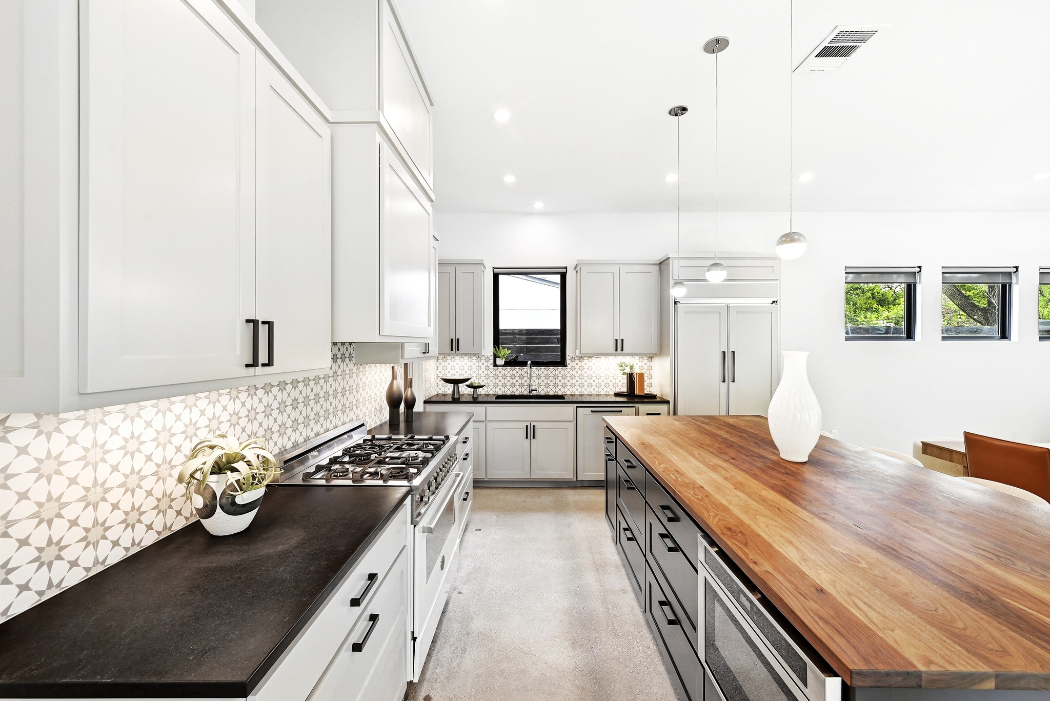1609 Bauerle Avenue Austin, TX 78704 - Photo 7 of 34 Large Walnut Breakfast Bar / Island, Bertazzoni gas range, and built in appliances with custom cabinetry panels