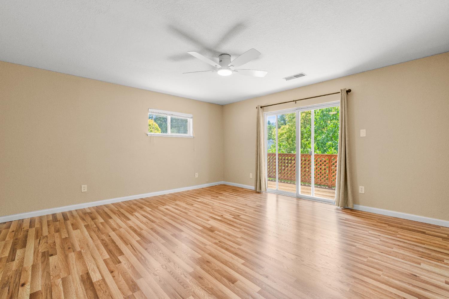 24126 Green Valley Road Auburn, CA 95602 - Photo 12 of 65 a view of an empty room with wooden floor and a window