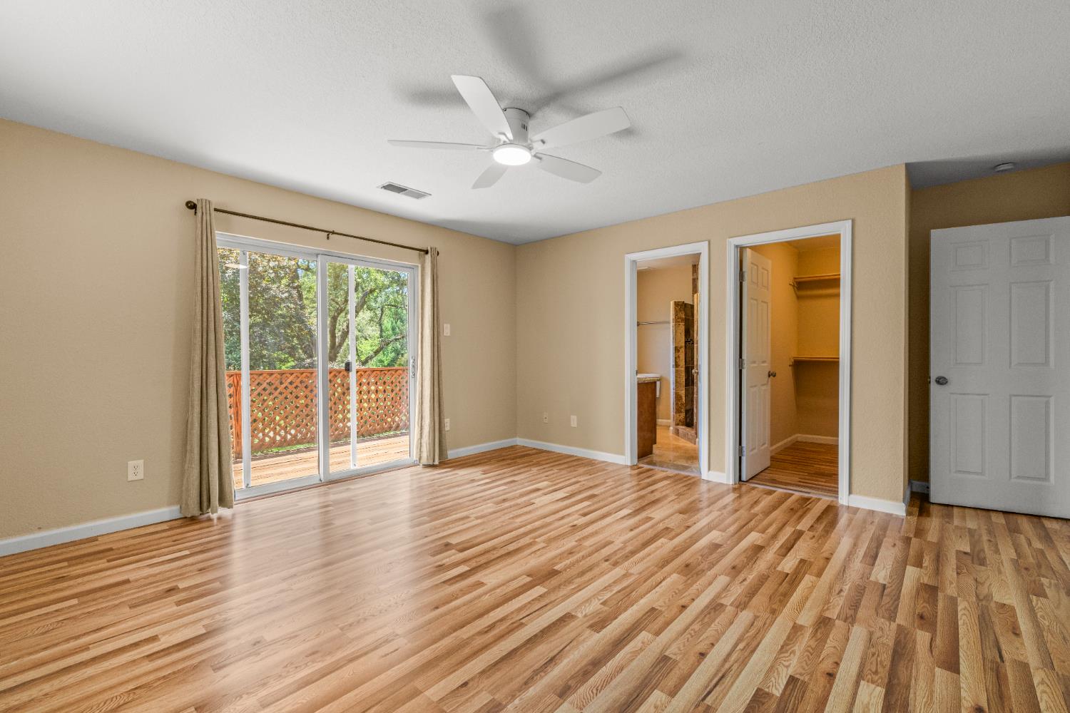 24126 Green Valley Road Auburn, CA 95602 - Photo 13 of 65 a view of an empty room with wooden floor and a window