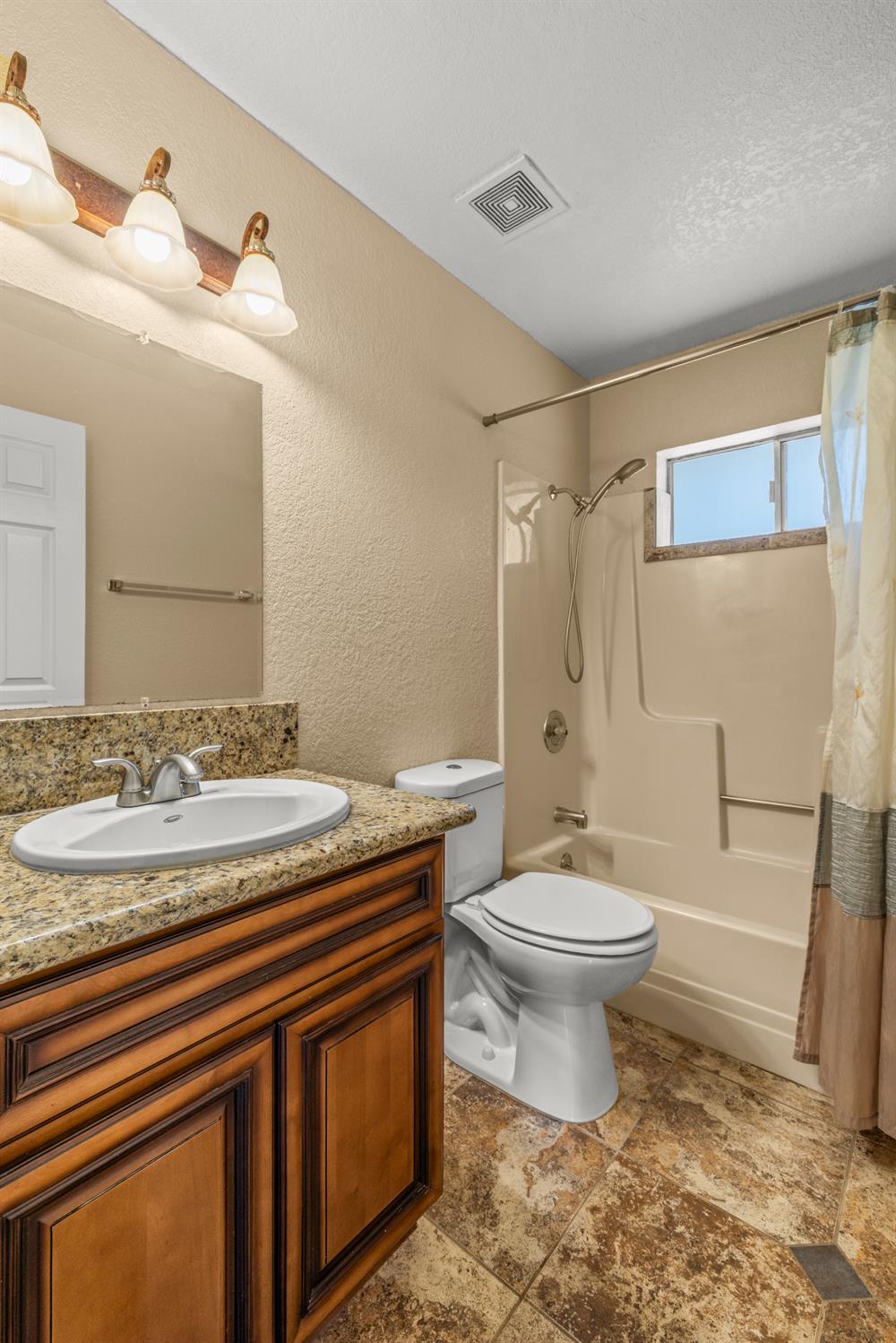 24126 Green Valley Road Auburn, CA 95602 - Photo 16 of 65 a bathroom with a sink a toilet and shower