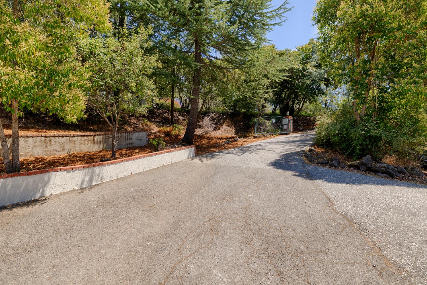 24126 Green Valley Road Auburn, CA 95602 - Photo 34 of 65 a view of a street with trees and covered with wooden fence