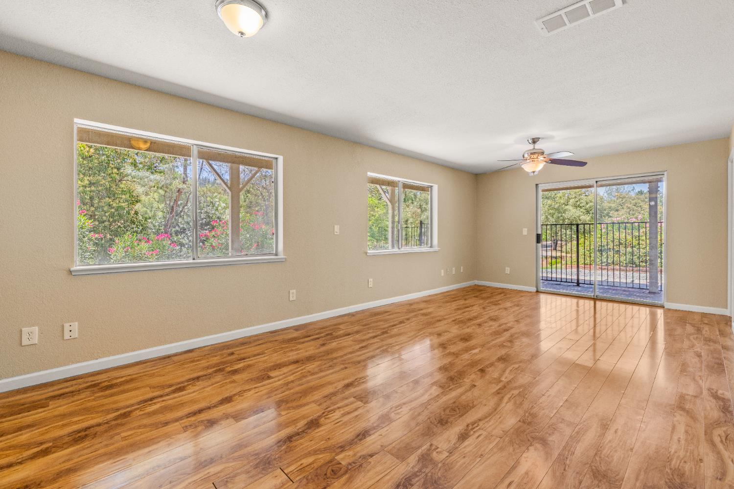 24126 Green Valley Road Auburn, CA 95602 - Photo 36 of 65 a view of an empty room with wooden floor and a window