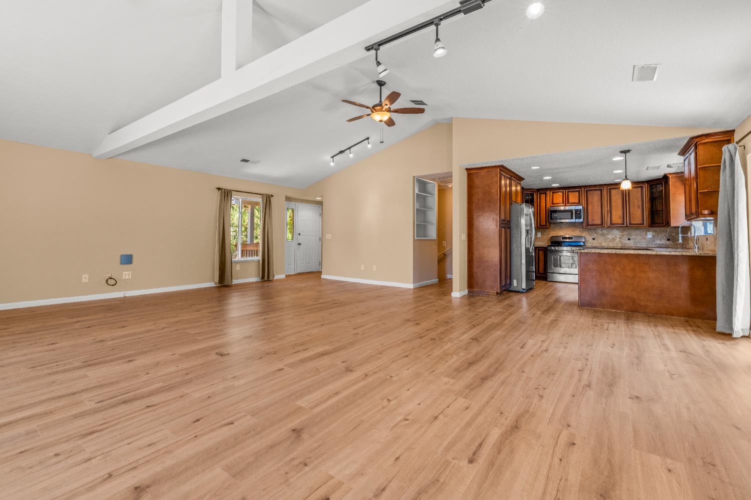 24126 Green Valley Road Auburn, CA 95602 - Photo 5 of 65 a view of a kitchen with wooden floor and a ceiling fan in a room