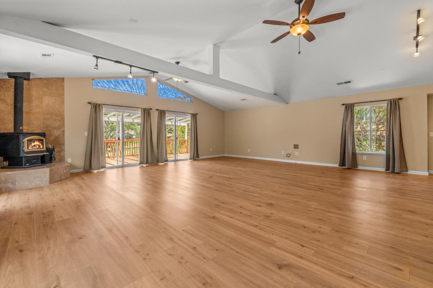 24126 Green Valley Road Auburn, CA 95602 - Photo 7 of 65 a view of an empty room with a window and wooden floor