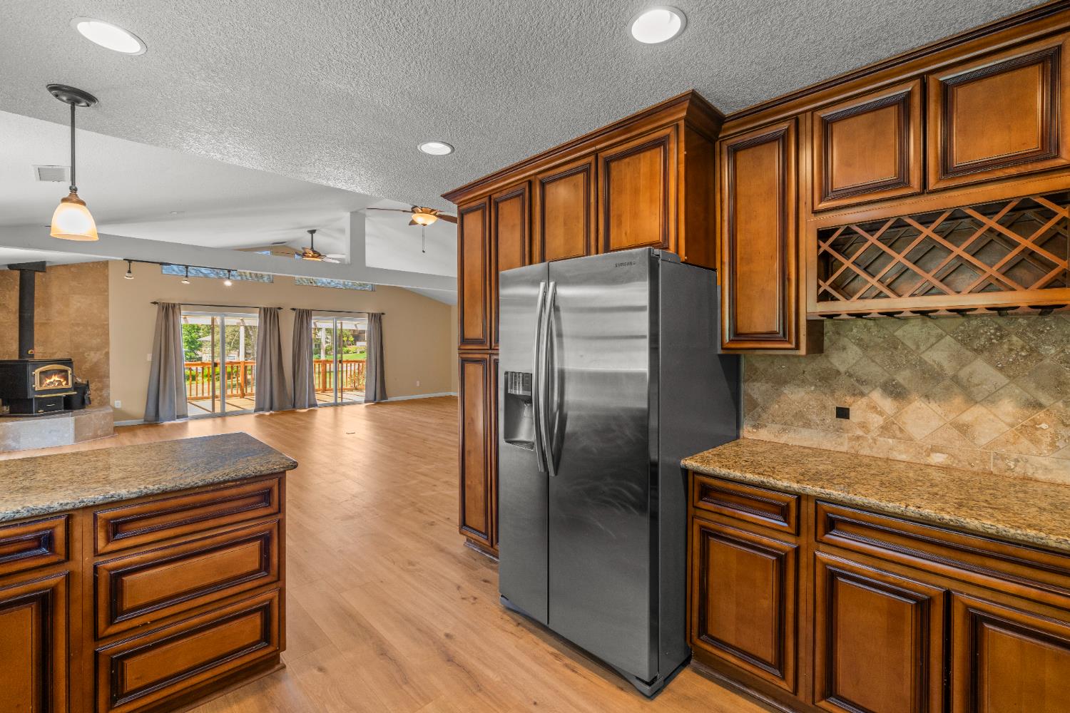24126 Green Valley Road Auburn, CA 95602 - Photo 9 of 65 a kitchen with stainless steel appliances granite countertop a refrigerator a stove and a sink with cabinets