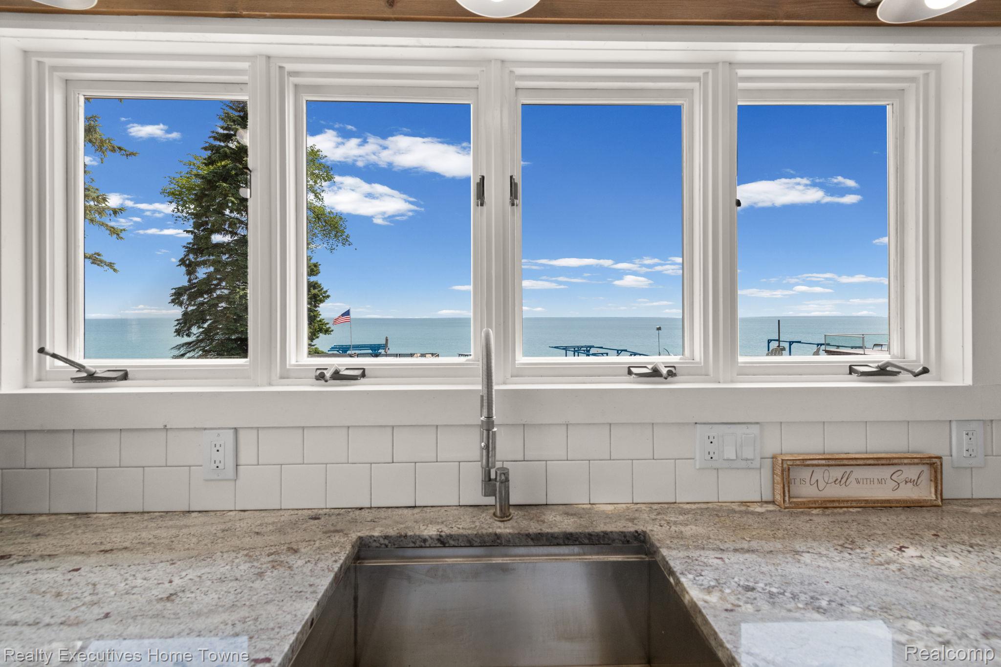 8308 Lakeshore Road Fort Gratiot, MI 48059 - Photo 41 of 79 Kitchen window overlooking a large body of water, featuring a stainless steel undermount sink and a granite-finish countertop