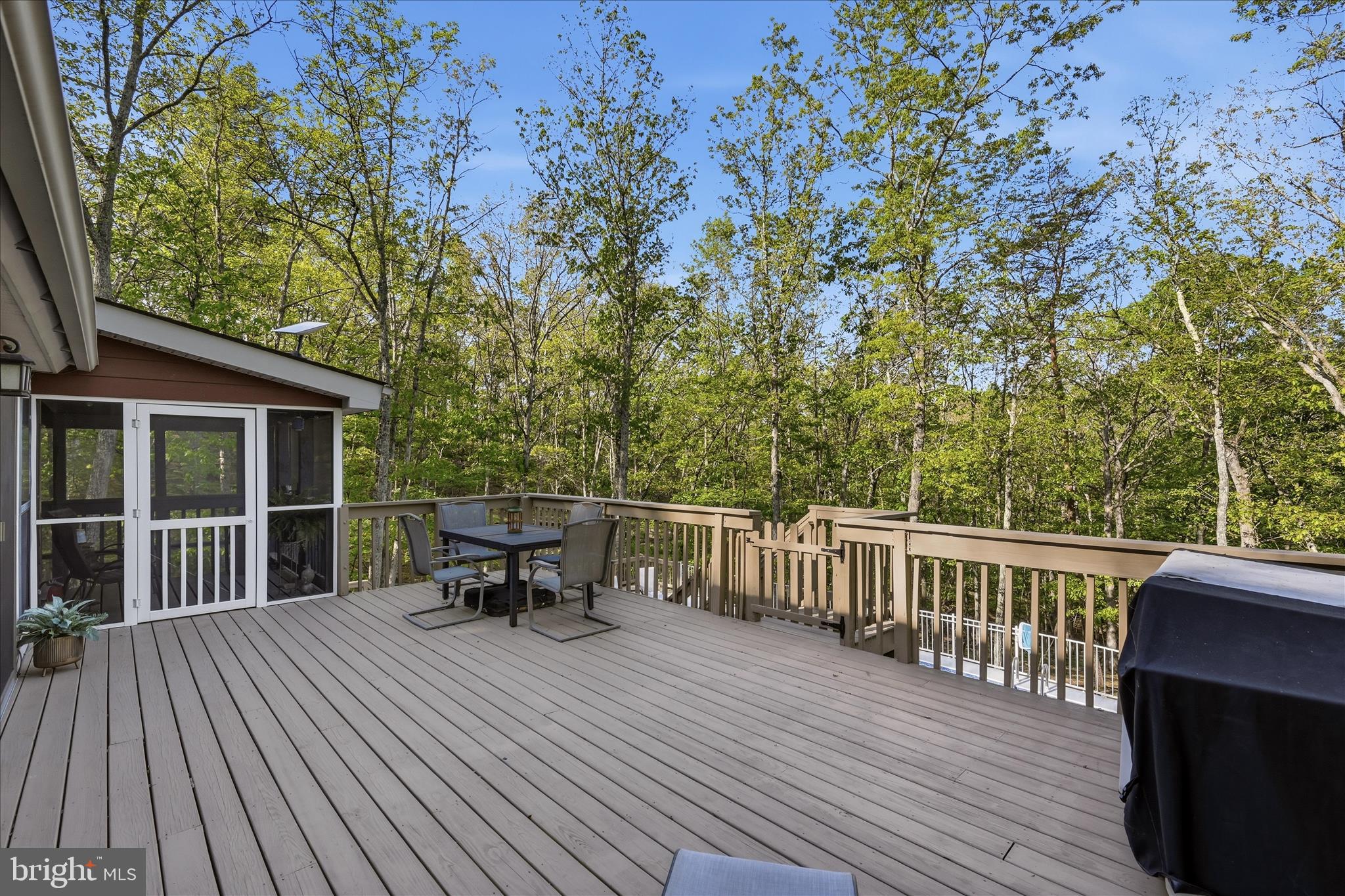 1856 Crossings View Road Paw Paw, WV 25434 - Photo 17 of 45 a view of a chair and table on the wooden deck
