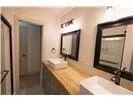 a bathroom with a sink a mirror and a vanity