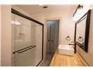 a bathroom with a glass shower door