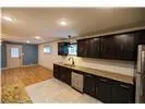 a kitchen with stainless steel appliances granite countertop a sink a stove and a refrigerator